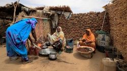 FILE PHOTO: Sudan refugees who fled violence in Darfur region take refuge in a house near the border between Sudan and Chad in May.
