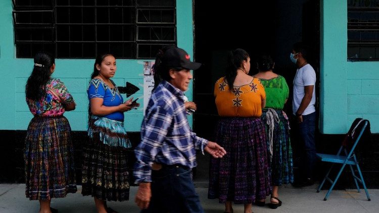 Voters queue outside a polling station in Chinautla on Sunday