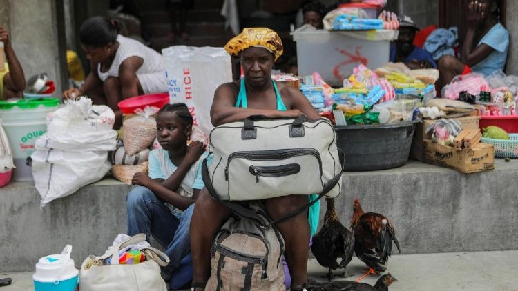 People shelter at a school after gangs took over their neighbourhood, in Port-au-Prince