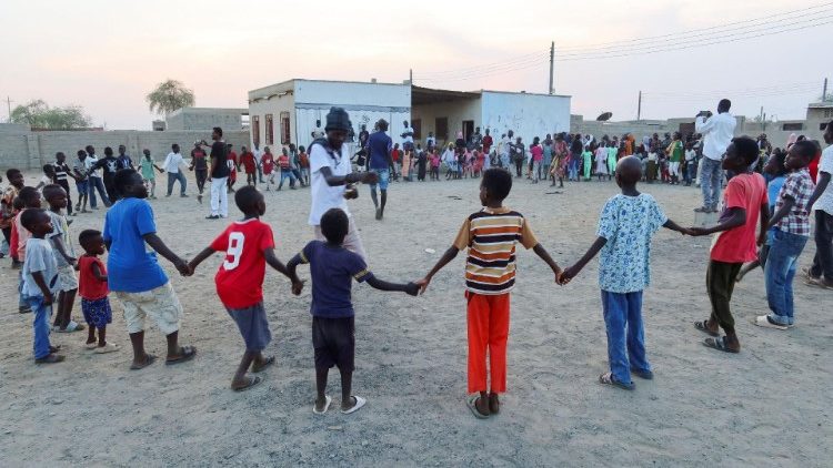 General Kidi and Ganja Famer, members of the Nuba Mountain Sound band, train children to dance in Port Sudan