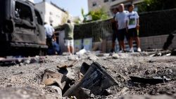 The remains of a rocket fired from the Gaza Strip into Israel lies on a road where it fell in Ashkelon, southern Israel