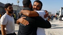 A Palestinian labourer, who was in Israel during the Hamas October 7 attack, is greeted as he arrives at the Rafah border after being sent back by Israel to the strip, in the southern Gaza Strip