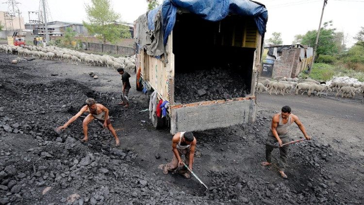 FILE PHOTO: Labourers load coal onto a supply truck on the outskirts of Jammu