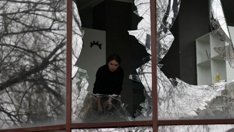 Uma mulher remove cacos de vidro de janelas quebradas de um prédio que abriga um salão de beleza, após recente bombardeio durante o conflito Rússia-Ucrânia em Donetsk, Ucrânia controlada pela Rússia, 3 de dezembro de 2023. REUTERS/Valery Melnikov