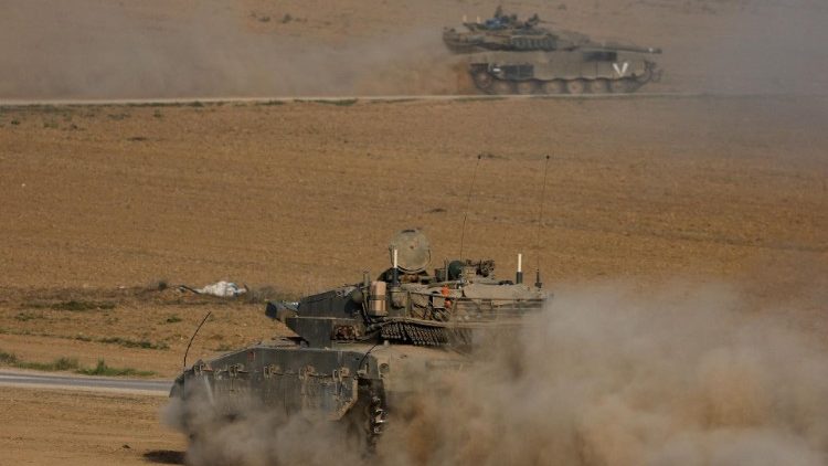 A tank manoeuvres outside the border with central Gaza