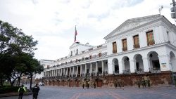 Soldiers and police officers stand guard outside the presidential palace in Quito