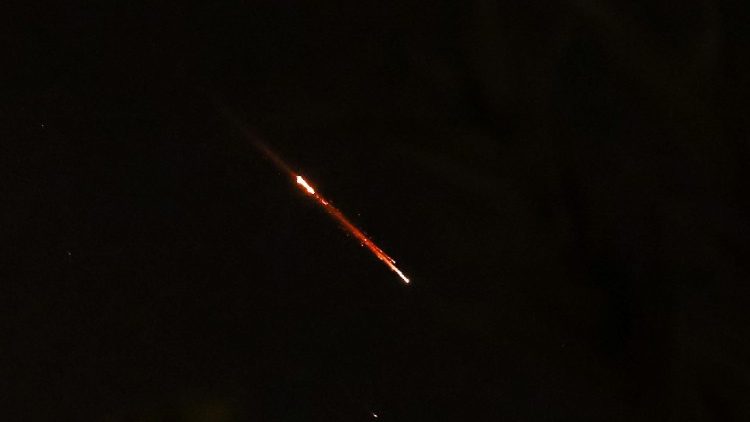 Objects are seen in the sky above Jerusalem after Iran launched drones and missiles towards Israel, in Jerusalem
