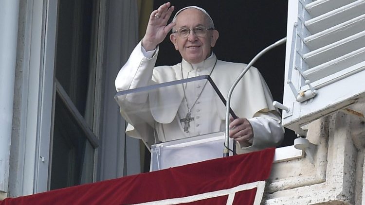 Pope Francis waves to the faithful during the Angelus on New Year's Day, the Solemnity of Mary the Mother of God