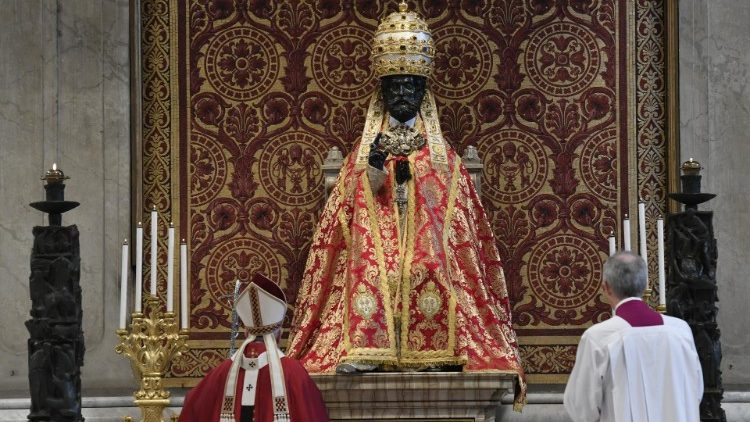 Pope Francis prays before the vested statue of St Peter at the beginning of Monday's liturgical celebration