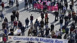 Members of a solidarity association in St. Peter's Square hold a banner reading: "World Rare Diseases Day"