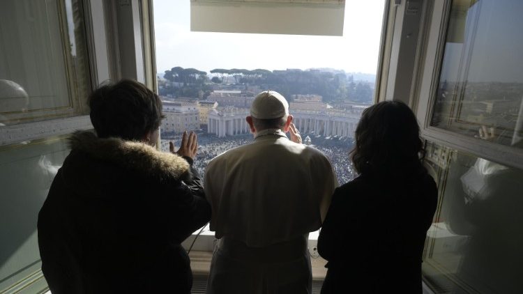 Pope Francis with two young people during the Angelus