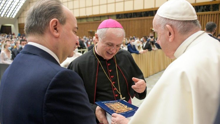Pope Francis is presented with the first copy of the book