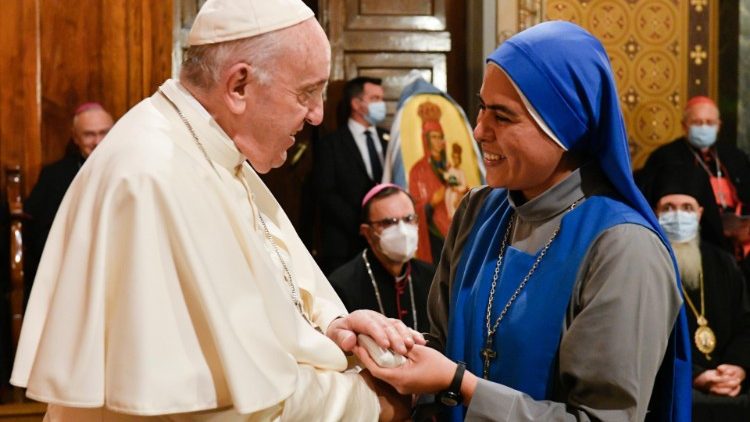 Pope Francis greets a Religious at a meeting in Athens' Catholic Cathedral