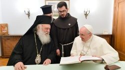 Su Beatitud Jerónimo II y el Papa Francisco firman el Libro de Honor, en la visita de cortesís en la Nunciatura Apostólica de Atenas.