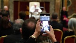 A journalists takes a picture of the Pope during Friday's audience