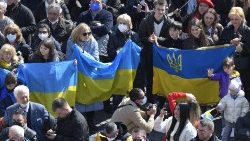 Des fidèles brandissant le drapeau ukrainien ce dimanche 6 mars 2022 place Saint-Pierre.