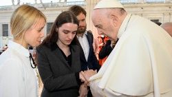 Pope Francis prays with Katheryna and Yulya