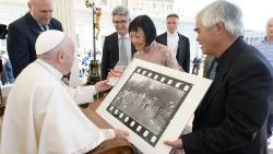 Kim Phúc Pahn Thi and Nick Ut present Pope Francis with a copy of the Pulitzer-prize winning photo of Kim fleeing the devastation of a napalm bomb attack on her village in Vietnam.