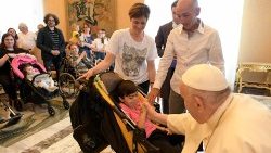 Pope Francis holds hands with Valentina, an Italian girl with Cornelia de Lange Syndrome