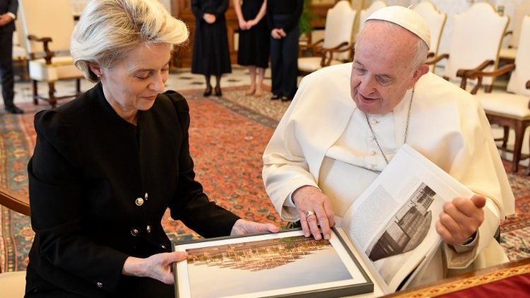 Pope Francis looks at a gift with Mr. Von der Leyen