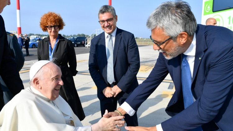 Pope Francis shakes hands with representatives of Italy's government