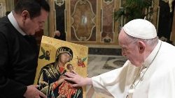 Pope Francis blesses an image of the Virgin Mary during his audience with Redemptorists