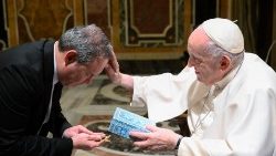 Pope Francis blesses a participant in the 'Christmas Contest'