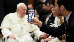 File photo of a pilgrim taking a video of Pope Francis