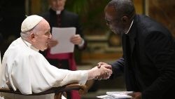 Pope Francis greets a member of the Italian Charity for the Promotion of Literacy in the World