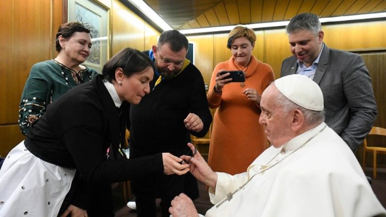 A metal bracelet from the steel works plant is given to the Pope