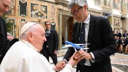Pope Francis is given a model of an ITA aeroplane during his audience with ITA Airways staff in the Vatican