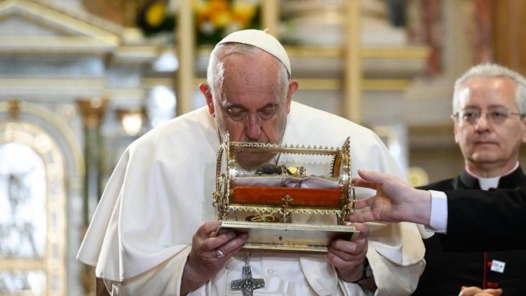 Pope Francis kisses a relic of St. Stephen's hand