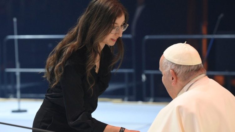 Pope Francis greets one of the young people who brought their testimony to the event