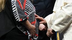 Pope Francis blesses a mother and her unborn child