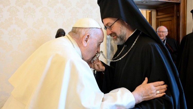Pope Francis kisses the "panagia" of Archbishop Job