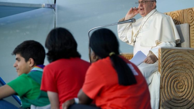 Pope Francis listens for a response after inviting young people to repeat after him