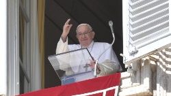Pope Francis waves at the faithful during his Angelus prayer