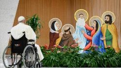 Pope Francis pauses before the Nativity scene in the Paul VI Hall