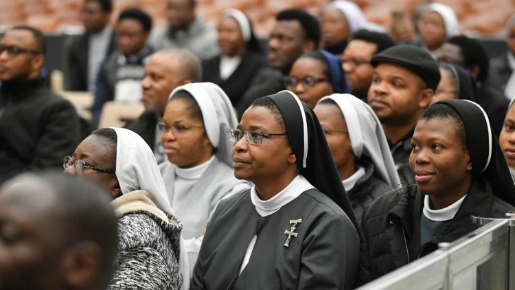 Participants listen to the Pope's address