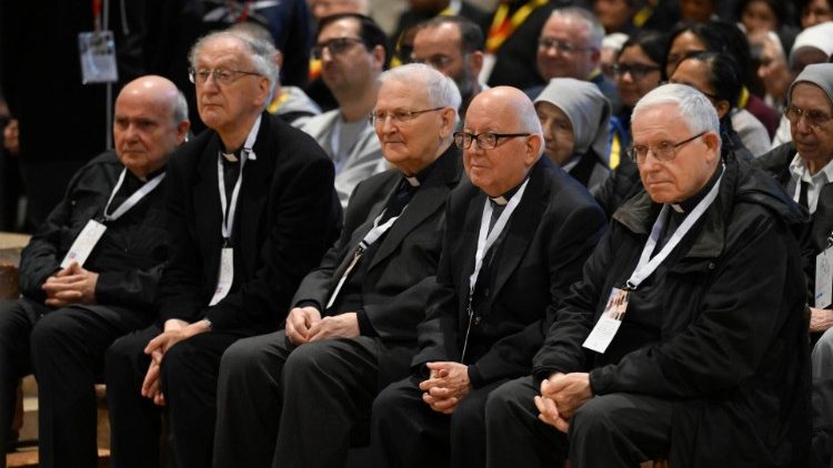 Priests in the front row listen to Pope Francis