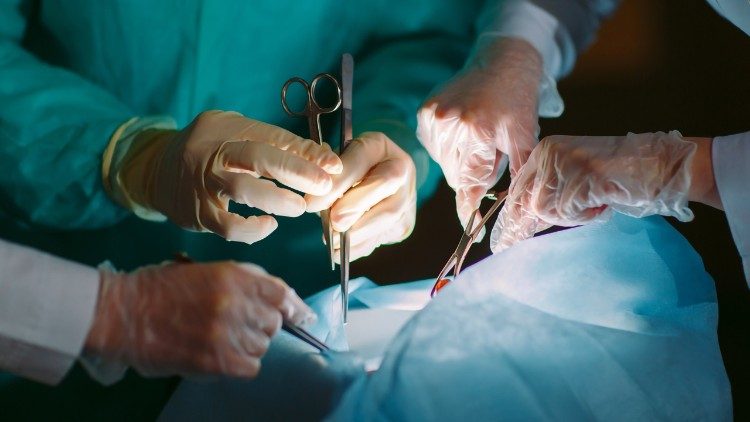 Surgeons performing an organ transplant