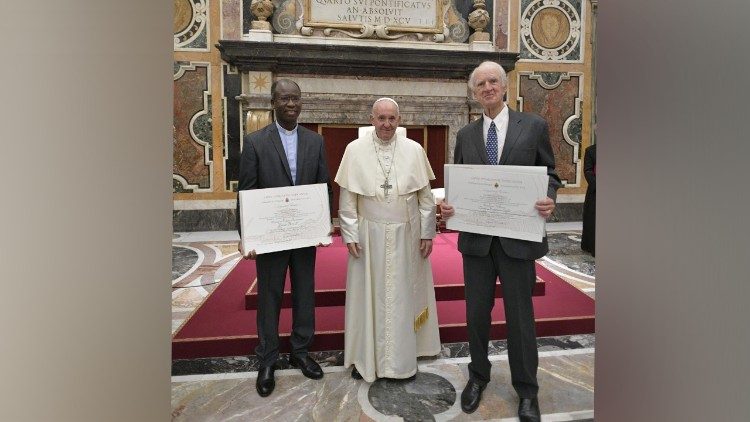 Jesuit priest Father Paul Béré  (L) and Professor Charles Margrave Taylor, (R)  together with Pope Francis. 