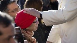Pope Francis blesses an elderly woman