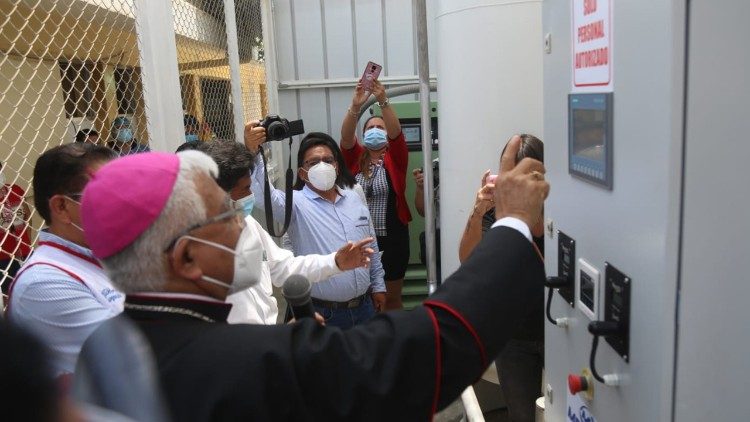 Archbishop Miguel Cabrejos blesses an oxygen-bottling machine as part of "Breathe, Peru"