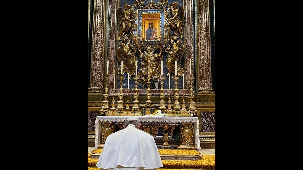 Pope Francis bows his head in prayer before Our Lady's image in St. Mary Major