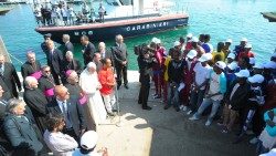 Pope Francis prays with migrants during his 2013 visit to Lampedusa