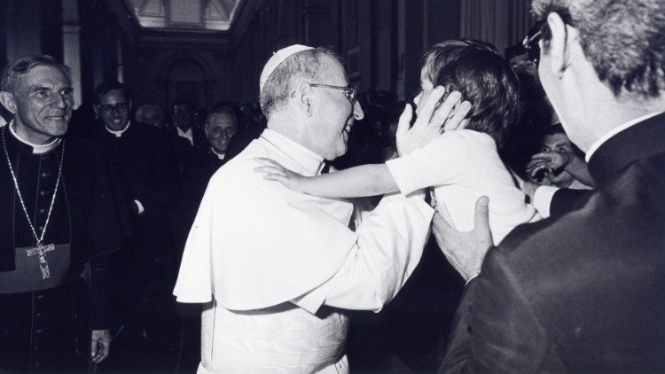 Pope John Paul I embraces a child 