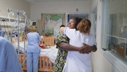 A mother and a nurse embrace at the Bambino Gesu' hospital