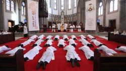 The men lie prostrate in prayer as they await ordination