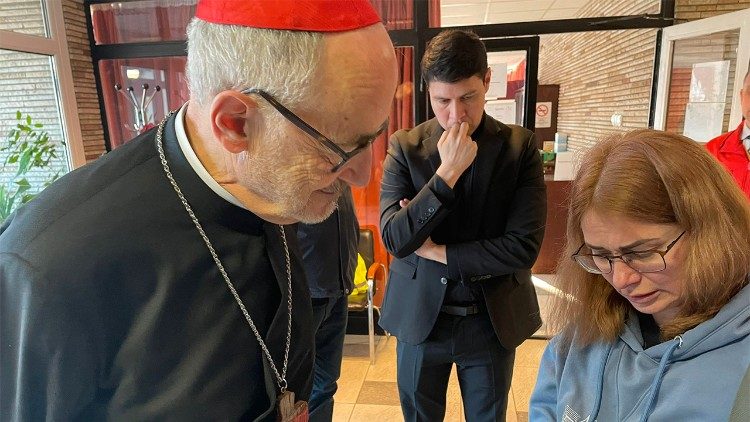 Natalia shows the Cardinal a photo of her parents who remain in Ukraine
